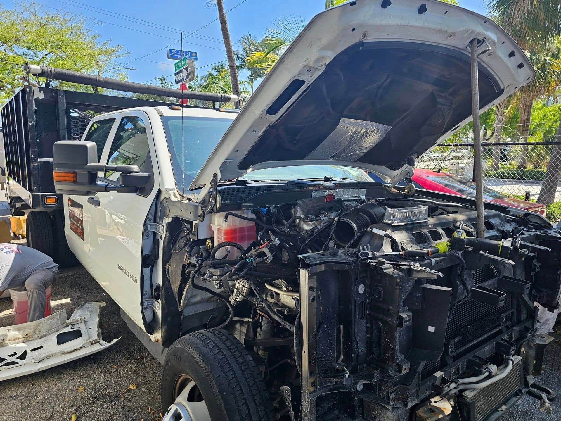 White work truck with the front end disassembled for collision repair