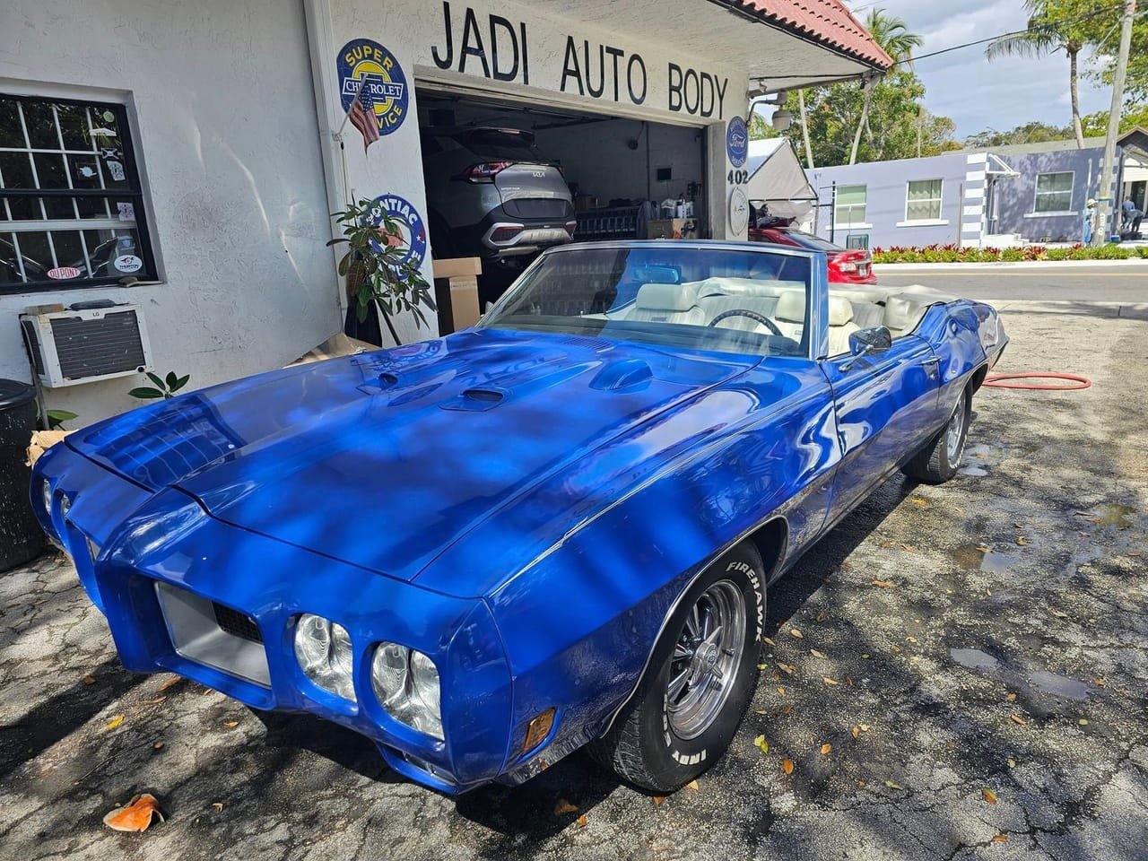 Freshly refinished classic blue convertible parked outside the Jadi shop at 402 SE 5th Ave in Delray Beach